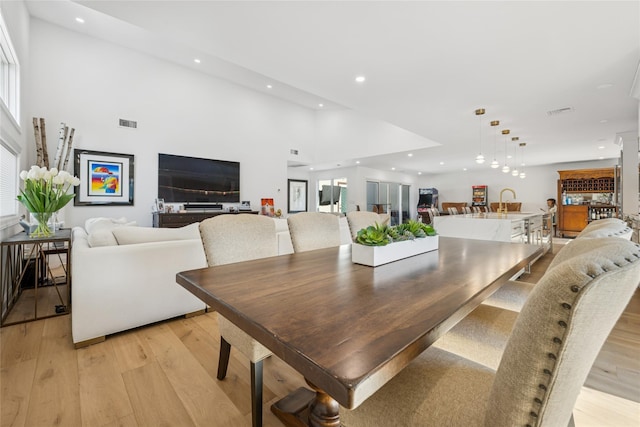 dining room with visible vents, recessed lighting, light wood-type flooring, and a healthy amount of sunlight