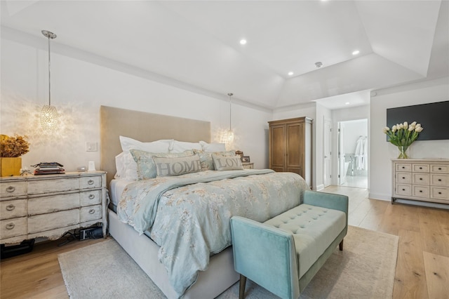 bedroom featuring recessed lighting, an inviting chandelier, vaulted ceiling, and light wood finished floors