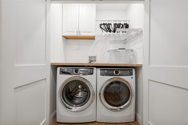 laundry area featuring cabinet space and separate washer and dryer