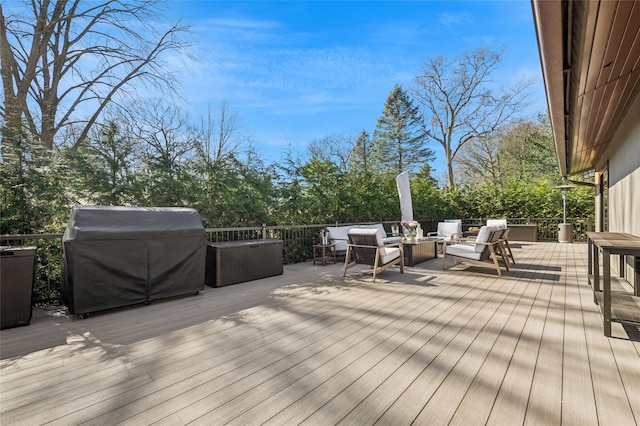 wooden terrace featuring grilling area and an outdoor hangout area