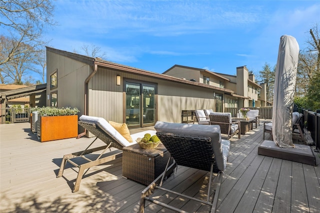 wooden deck with an outdoor living space