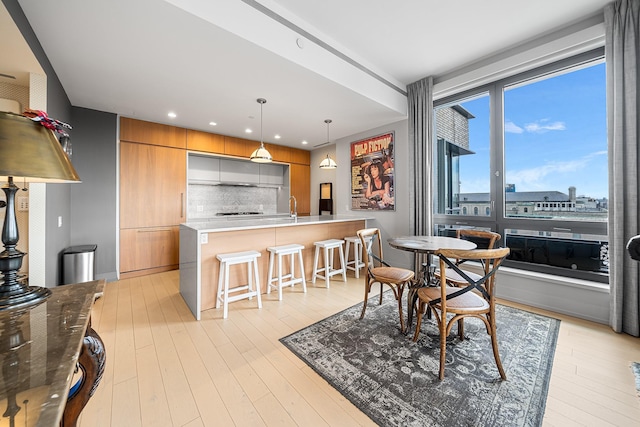 dining room with light wood-style flooring and recessed lighting