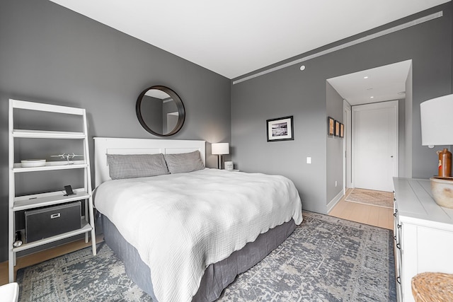 bedroom featuring wood finished floors and baseboards