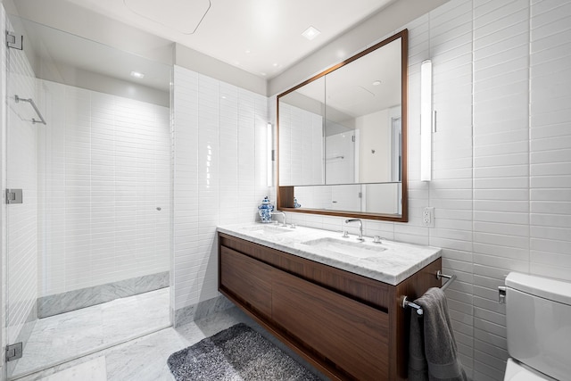 full bath with tiled shower, a sink, and tile walls