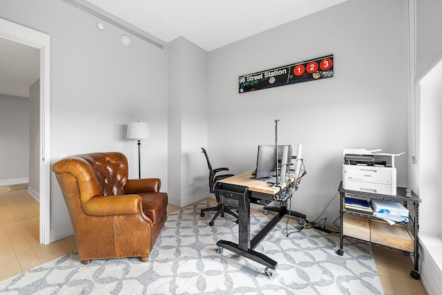 office featuring light wood-type flooring and baseboards