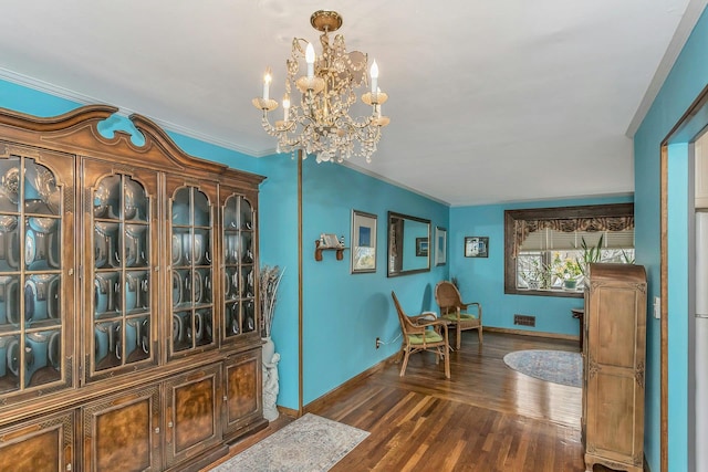 sitting room featuring a notable chandelier, visible vents, ornamental molding, wood finished floors, and baseboards