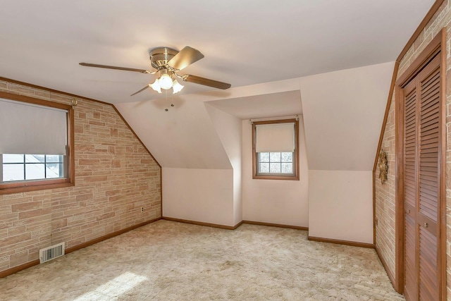 bonus room featuring ceiling fan, visible vents, vaulted ceiling, and carpet flooring