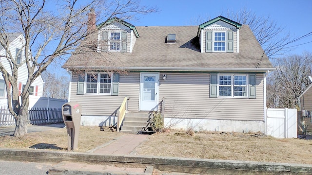 view of front of property featuring a shingled roof and fence