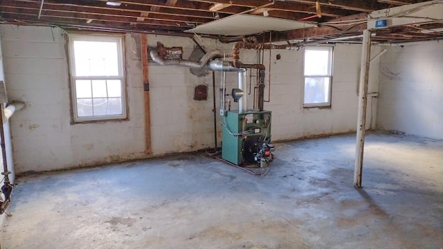 basement with a heating unit and concrete block wall