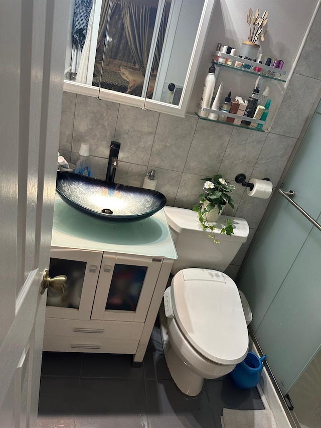 half bathroom featuring toilet, tile patterned floors, tasteful backsplash, and vanity