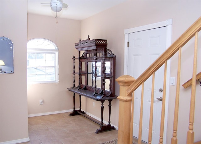 interior space with baseboards and tile patterned floors