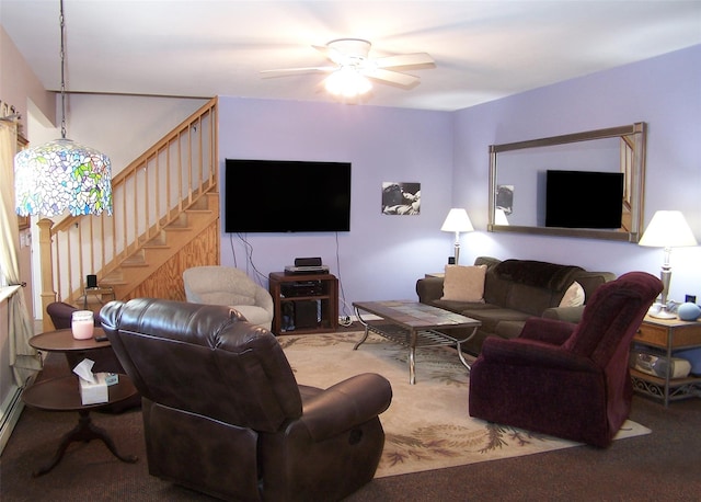 living area featuring carpet floors, ceiling fan, and stairs