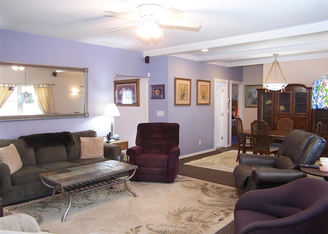 carpeted living room with beamed ceiling, baseboards, and ceiling fan