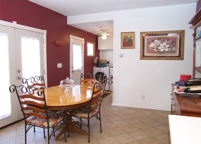 dining space with baseboards, ceiling fan, french doors, separate washer and dryer, and light tile patterned flooring