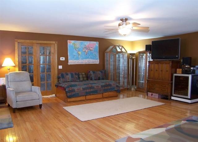 living area featuring ceiling fan and wood finished floors