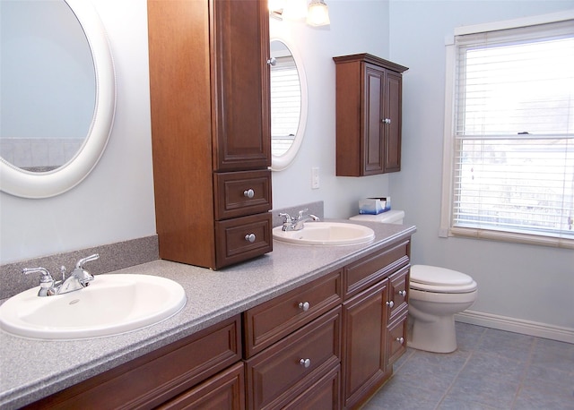 bathroom with a healthy amount of sunlight, a sink, and toilet