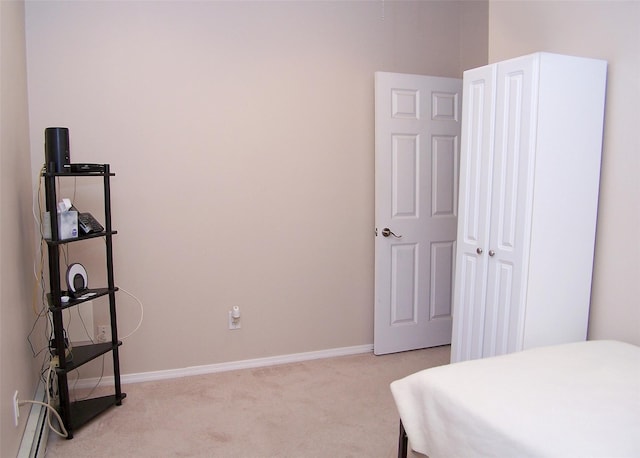 carpeted bedroom featuring baseboards