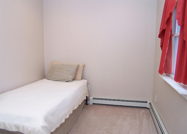 bedroom featuring a baseboard heating unit, a baseboard radiator, and carpet flooring