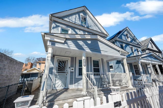 view of front of house with a porch and a fenced front yard