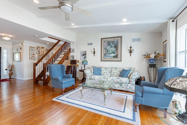 living room with recessed lighting, wood finished floors, visible vents, stairway, and beamed ceiling