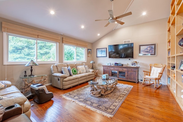 living area featuring high vaulted ceiling, light wood finished floors, a ceiling fan, and recessed lighting