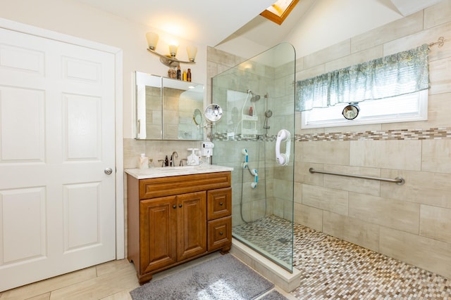 full bath featuring vaulted ceiling, walk in shower, and vanity