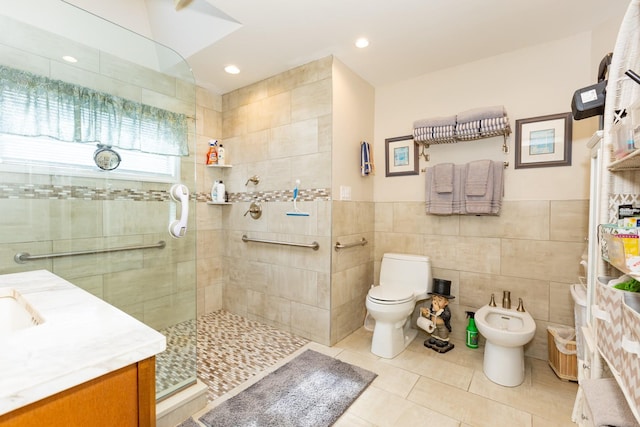 full bath with tile patterned flooring, toilet, tile walls, a bidet, and walk in shower