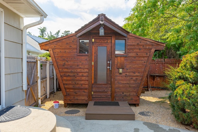 view of shed featuring fence