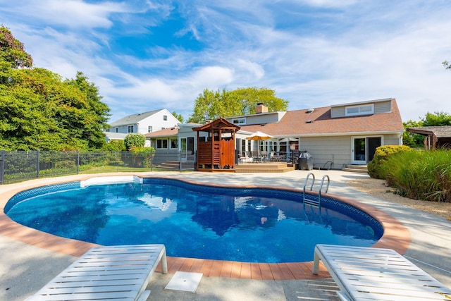 view of swimming pool featuring a fenced in pool, entry steps, fence, and a wooden deck