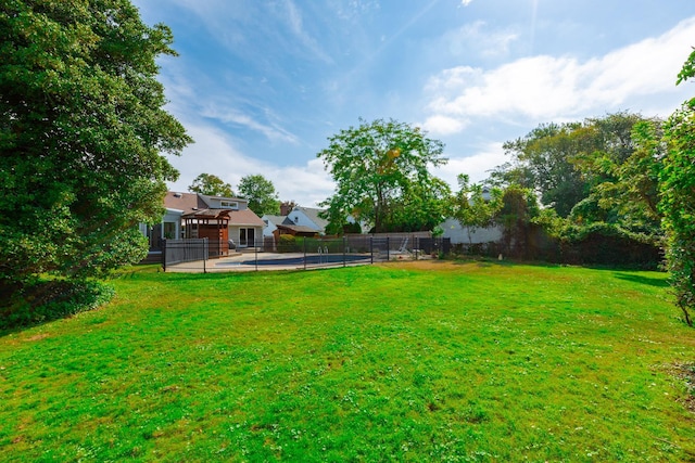 view of yard with a fenced in pool and fence