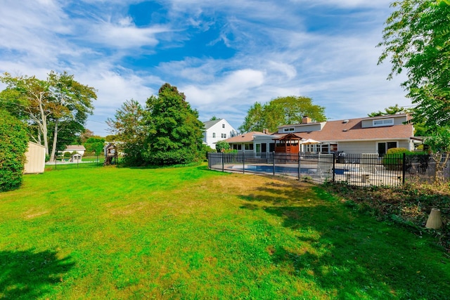 view of yard featuring fence and a fenced in pool