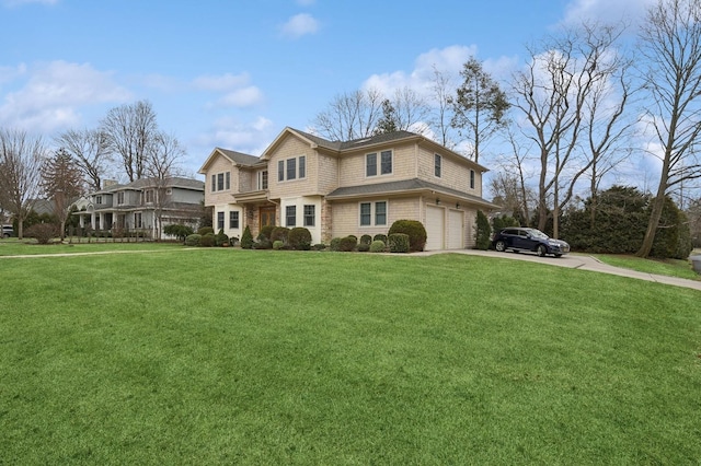 view of front of property featuring driveway, a front lawn, and an attached garage