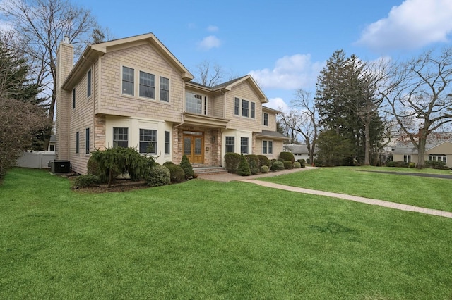 view of front of house featuring central AC, a front lawn, a chimney, and fence