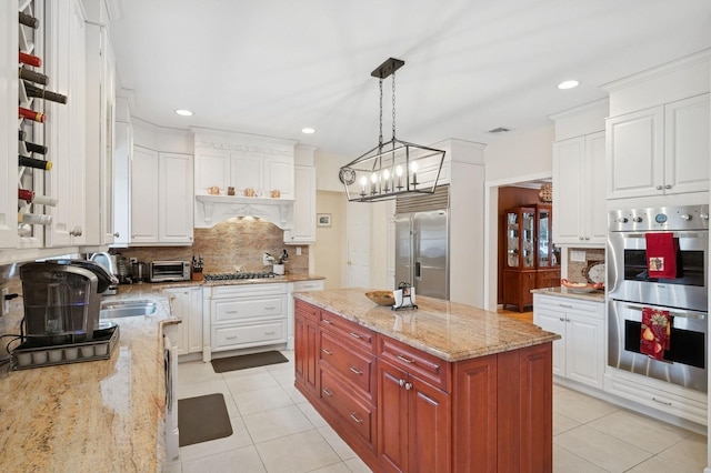 kitchen with light tile patterned floors, white cabinetry, and appliances with stainless steel finishes