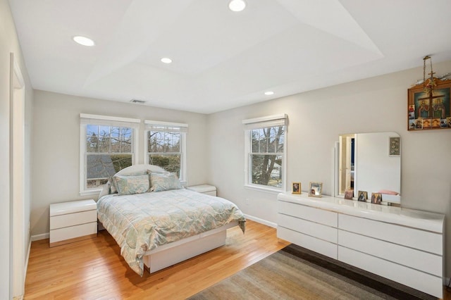 bedroom featuring light wood-style floors, baseboards, and visible vents