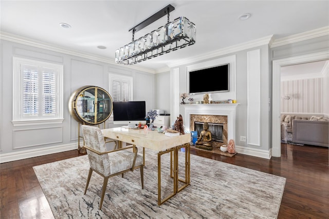 home office featuring ornamental molding, a high end fireplace, a decorative wall, and hardwood / wood-style floors