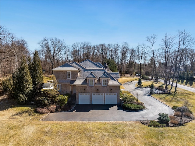 shingle-style home featuring driveway and a front lawn