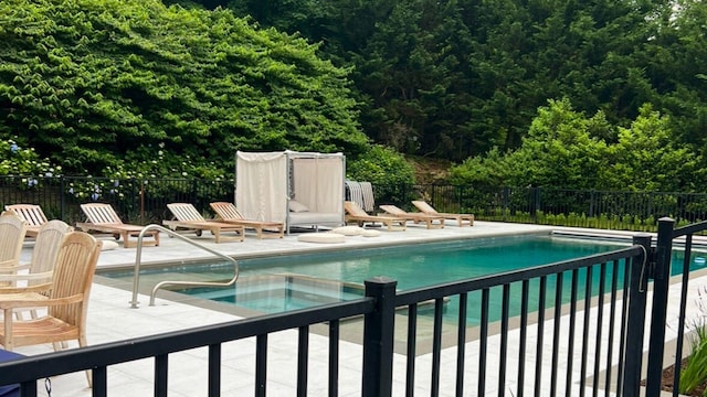 pool featuring fence, a community hot tub, and a patio