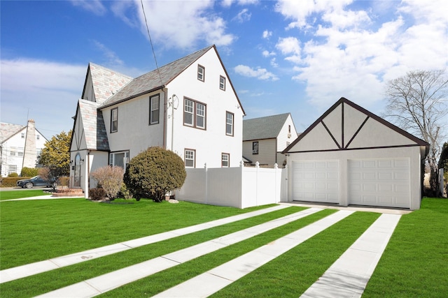 view of side of property featuring a garage, stucco siding, fence, and a yard