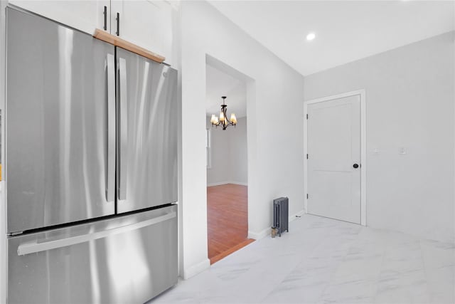 kitchen with marble finish floor, recessed lighting, an inviting chandelier, freestanding refrigerator, and white cabinets