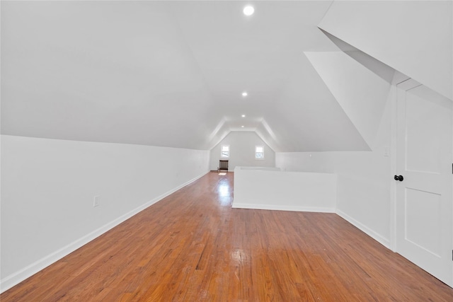 bonus room featuring vaulted ceiling, recessed lighting, wood-type flooring, and baseboards