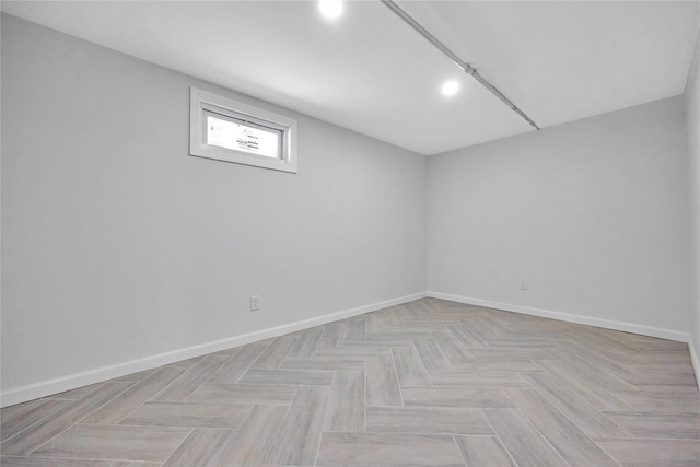 unfurnished room with baseboards