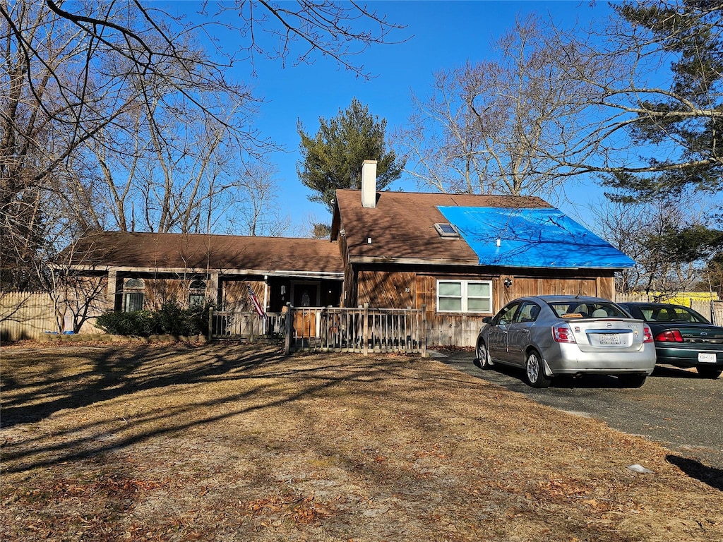 view of front of home with a front lawn and a chimney