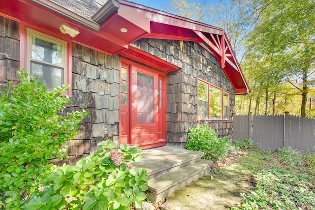 view of exterior entry with fence