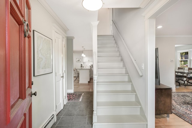 staircase featuring recessed lighting, baseboard heating, wood finished floors, and crown molding