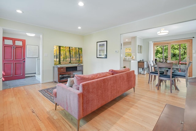 living area featuring ornamental molding, recessed lighting, light wood-style floors, baseboards, and baseboard heating