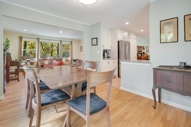 dining room with recessed lighting and light wood-type flooring