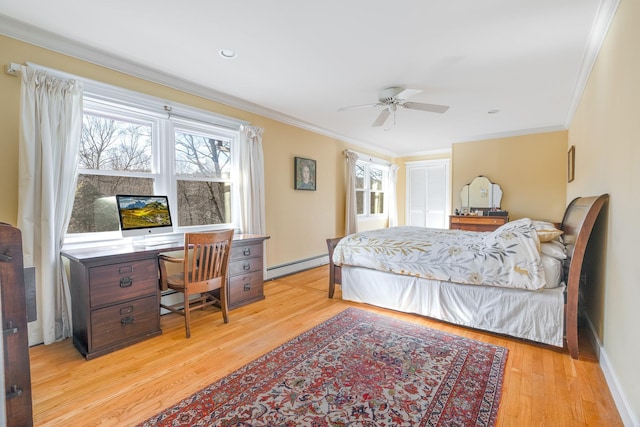 bedroom with a baseboard heating unit, multiple windows, light wood-style floors, and ornamental molding