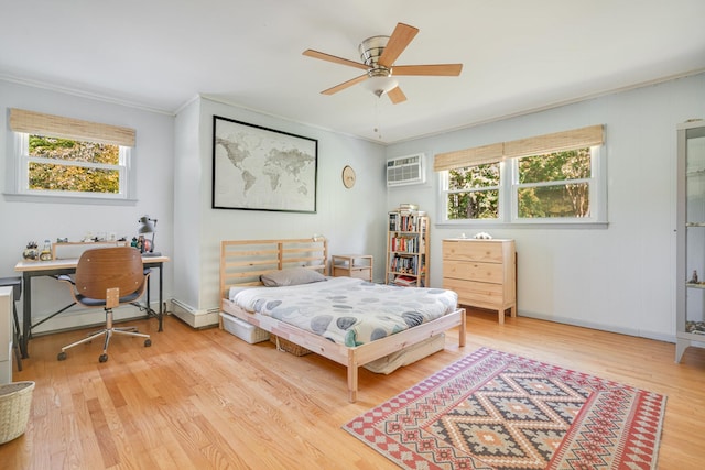 bedroom with an AC wall unit, ornamental molding, a ceiling fan, light wood finished floors, and baseboards