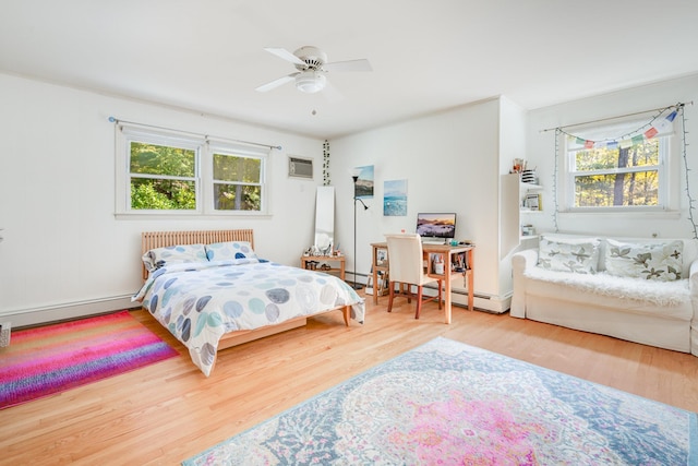 bedroom with a wall mounted air conditioner, a ceiling fan, wood finished floors, radiator, and a baseboard radiator